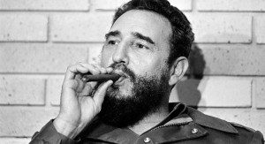 Fidel Castro, Prime Minister of Cuba, smokes a cigar during his meeting with two U.S. senators, the first to visit Castro's Cuba, in Havana, Cuba, Sept. 29, 1974.  (AP Photo)