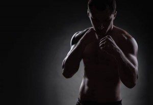 68177120 Fighter Silhouette Handsome Athletic Man In Boxing Stand On A Dark Background